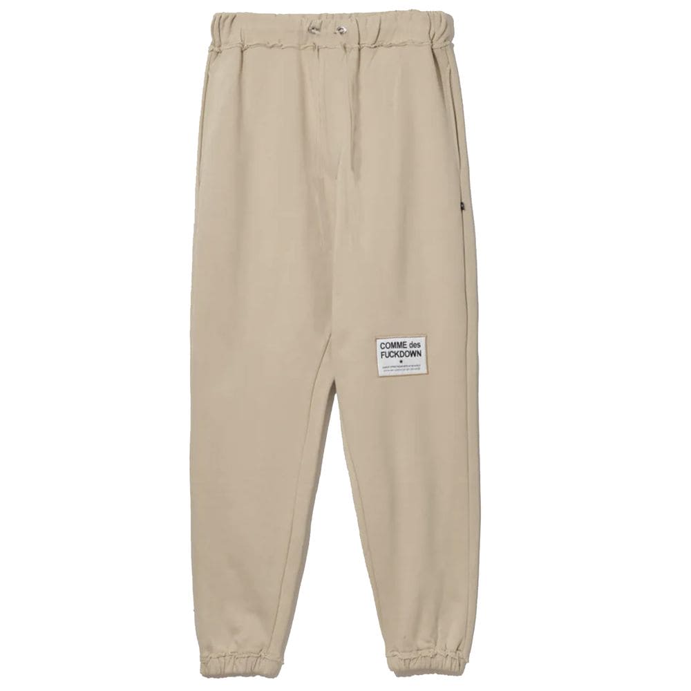 Pantalones deportivos elegantes de algodón beige con detalles deshilachados de Comme Des Fuckdown